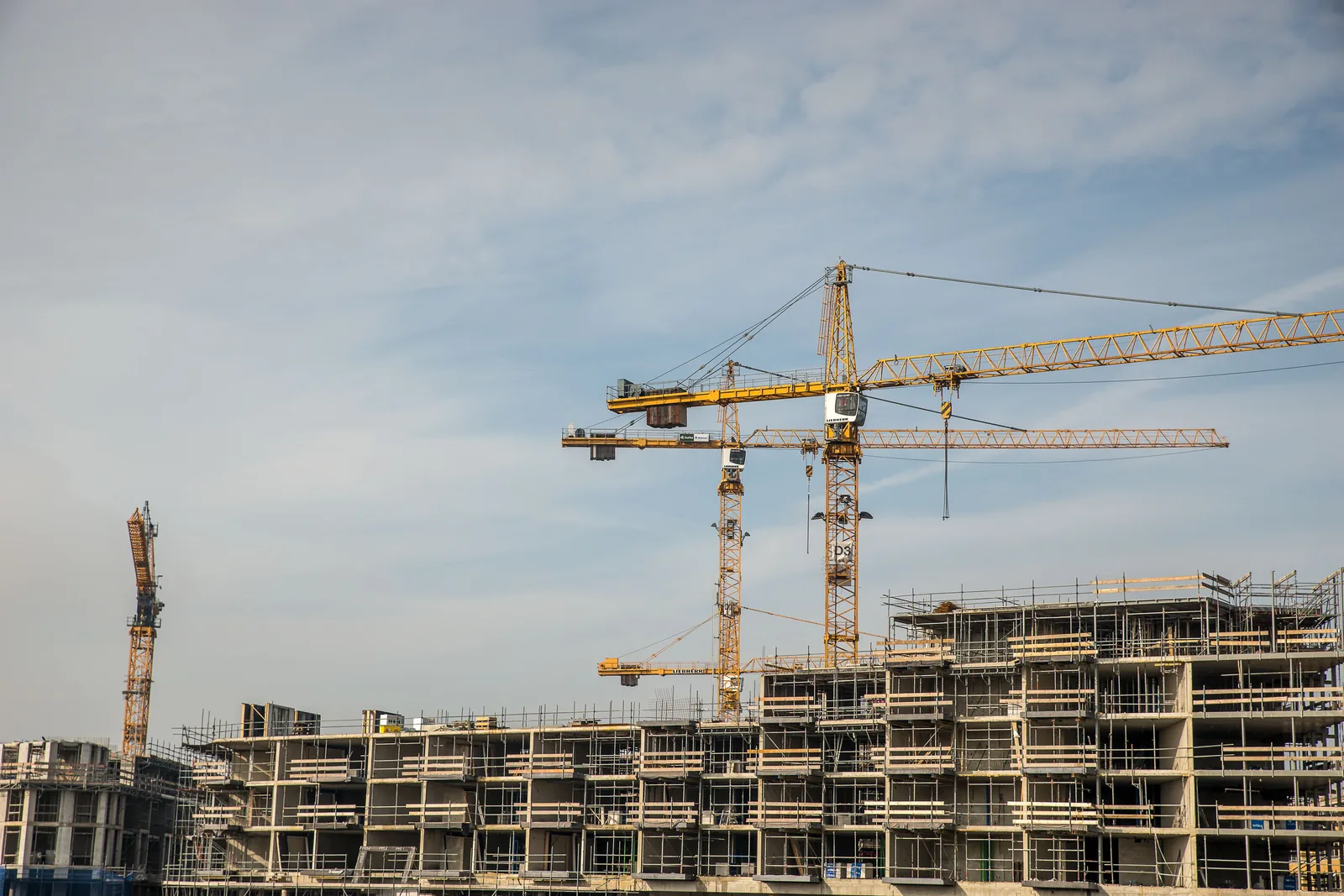 Illustrative active construction site with cranes